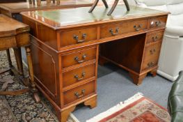 A yew wood pedestal desk.