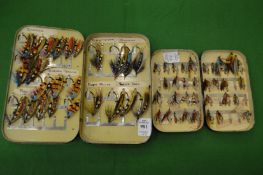 Two black Japanned travelling tins of fly fishing lures and hooks.