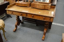A 19th century mahogany two drawer writing table with galleried back on turned and carved supports