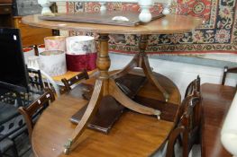 A mahogany twin pillar extending dining table with one leaf.