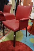 A good set of six stylish red leather upholstered reclining dining chairs with arms.