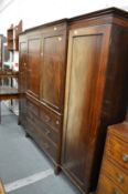 A large mahogany breakfront wardrobe or compactum, the central section with two panel doors above