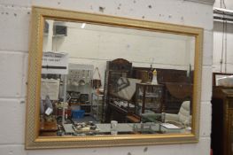 A gilt framed mirror.