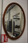 A mahogany oval mirror.