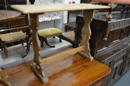 A small light oak refectory table.