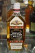 A bottle of Stewarts cream of the barley blended scotch whisky.