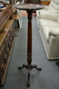 A mahogany torchere.