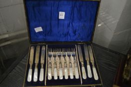 A cased set of six mother of pearl handled dessert knives and forks.