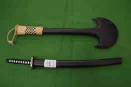 A miniature Samurai sword and another item.