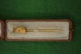 A gilt metal cat tie pin with original box.
