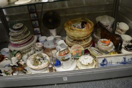 A large shelf of decorative china.