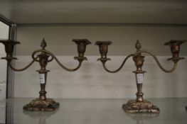 A pair of plated candelabra.