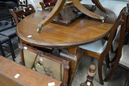 A mahogany extending dining table.