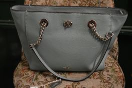 A Coach pale blue leather handbag.
