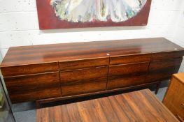 A Faarup Mobelfabrik Danish rosewood long sideboard designed by Ib Kofod-Larsen, comprising four