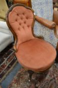A Victorian walnut framed button upholstered bedroom chair.