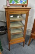 A small mahogany display cabinet.