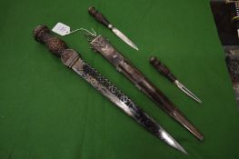 A very good Scottish dirk with a subsidiary knife and fork in a white metal mounted scabbard, the