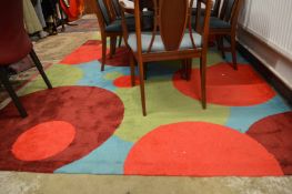 A large colourful abstract design rug 312cm x 202cm.