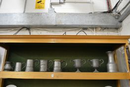 A good collection of pewter tankards and other items.