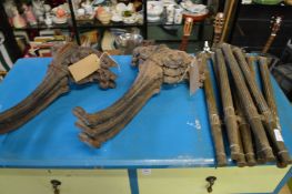 Brass table legs together with a set of six cast iron table legs.