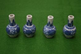 A set of four miniature Chinese blue and white vases.