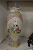 A Chinese famille rose baluster shaped vase and cover (rim damaged).