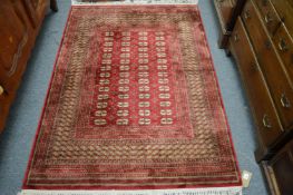 A modern Bokhara style rug 170cm x 118cm.