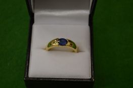 An 18ct gold ring set with a single sapphire.