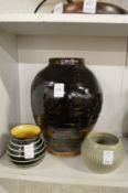 A large studio pottery vase and two smaller studio pottery bowls.