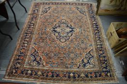 A Persian rug, rust ground with stylised decoration 190cm x 150cm.
