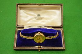 A ladies 18ct gold cased wrist watch with expanding bracelet by J W Benson, complete with original