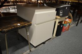 A small filing trolley, fax machine and other items.