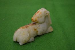 A small carved jade model of a goat.