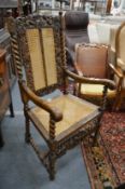 17th century style carved walnut armchair with cane work back panels and seat.