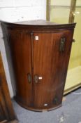 A George III mahogany bow front hanging corner cupboard.