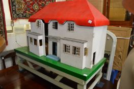 A large dolls house on stand with accessories.