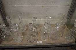 A good collection of cut glass decanters.