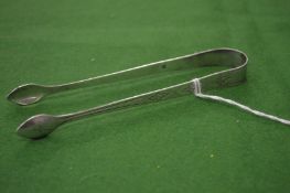 A pair of Georgian silver and bright cut engraved sugar tongs.