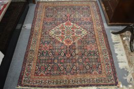 A Persian rug, blue ground with all over stylised decoration (some ware) 190cm x 130cm.
