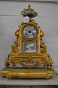A French ormolu and porcelain mantel clock on stand.