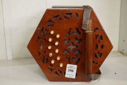 A mahogany concertina with instruction book.