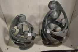 Two modern sculptures depicting family group.