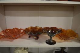 Four Carnival glass bowls.