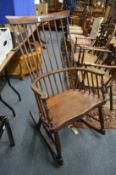 A spindleback rocking armchair.