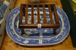 Small wooden stand and a large blue and white willow pattern meat plate.