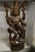 A large carved wood Eastern deity.