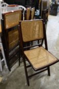 A set of four folding chairs.