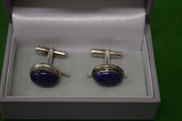 A pair of lapis cufflinks.
