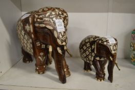 Two carved wood and bone inlaid models of elephants.